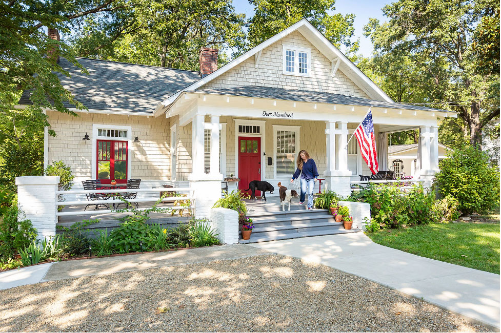 Historic home with cedar shake shingles and colorful red front door.