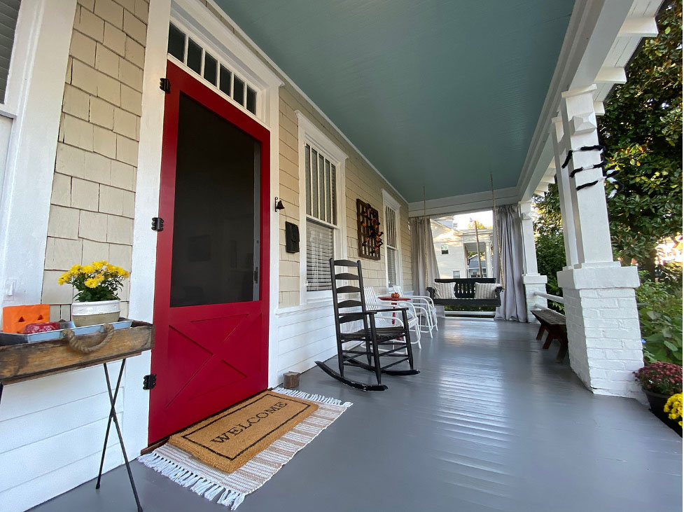 Front porch with red screen door.