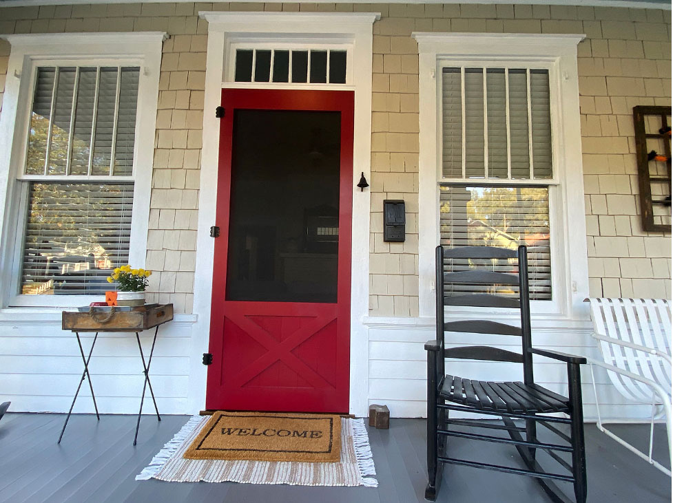 Red front door with screen.