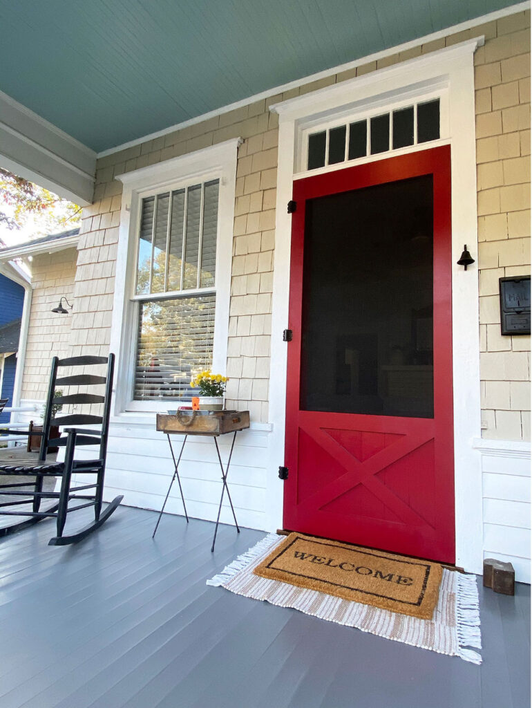 Red screen door on front porch.