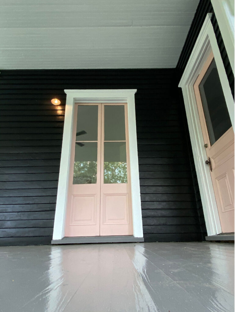 Black siding with soft pink exterior doors.